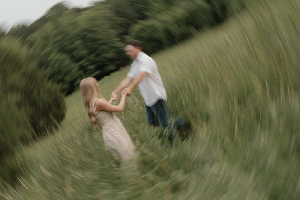 Couple in a sunlit field at Price Park in Greensboro, NC during golden hour