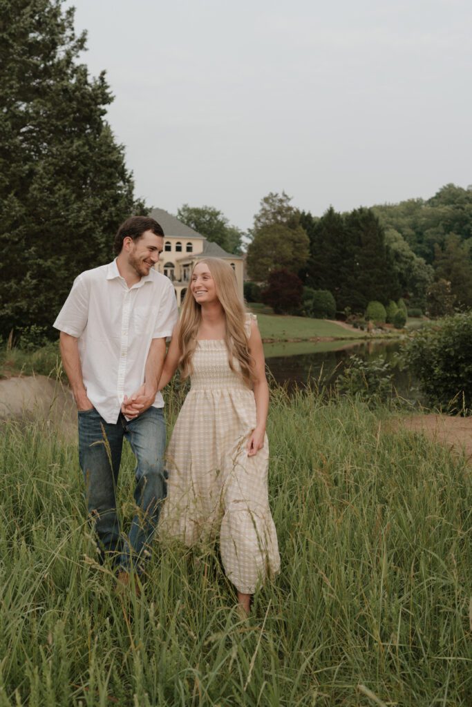 Couple in a sunlit field at Price Park in Greensboro, NC during golden hour