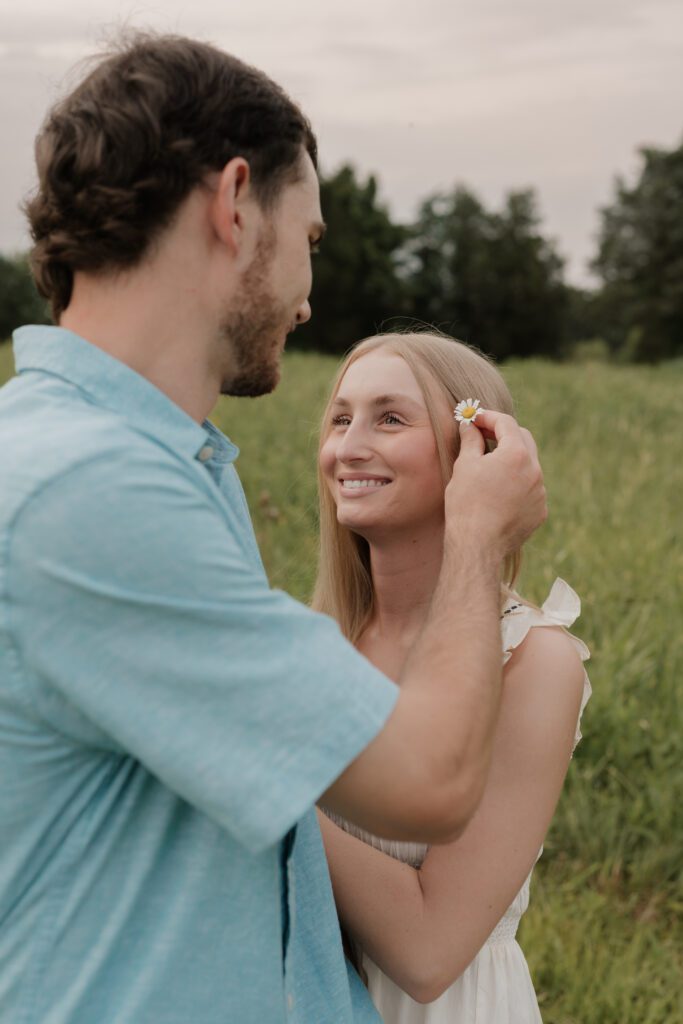 Couple in a sunlit field at Price Park in Greensboro, NC during golden hour