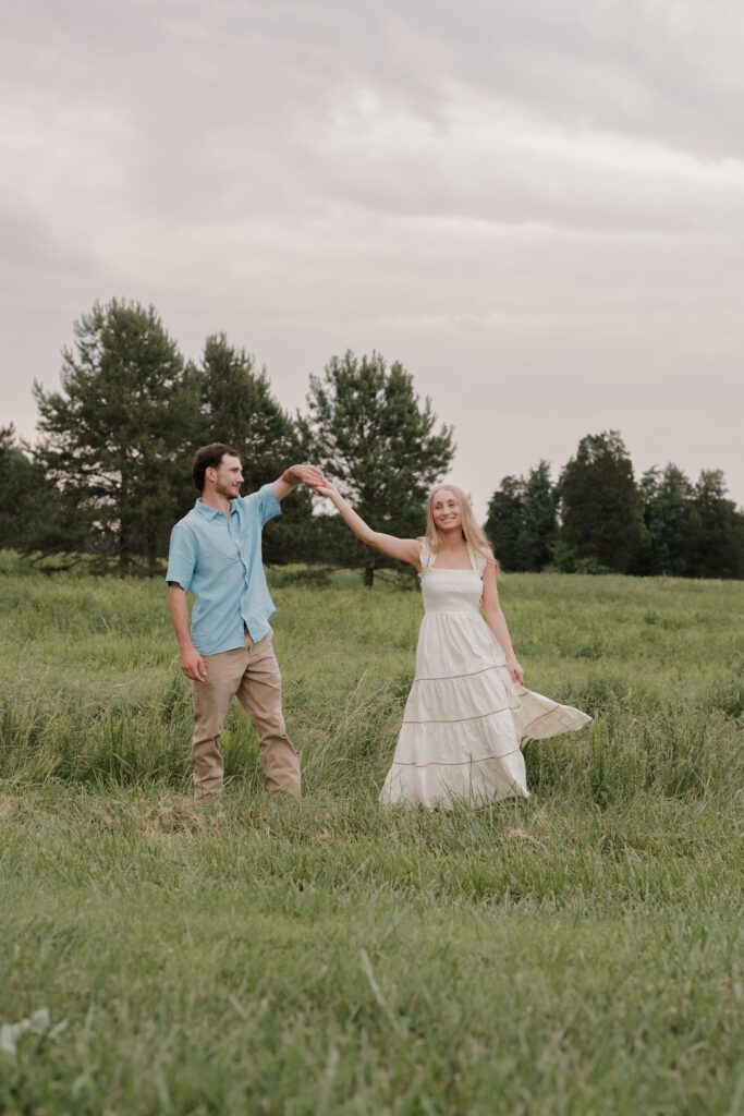Couple dancing in a sunlit field at Price Park in Greensboro, NC during golden hour