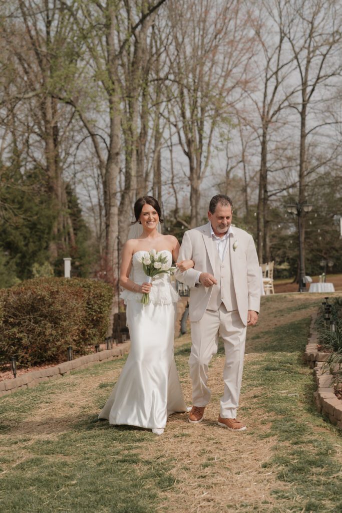 Bride walking down the aisle during lakeside wedding North Carolina ceremony