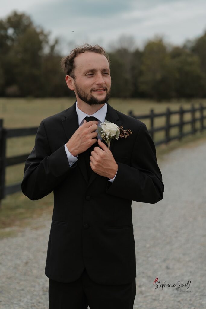 Bride and groom portrait in open field at Oakland Farms wedding venue in Sanford North Carolina