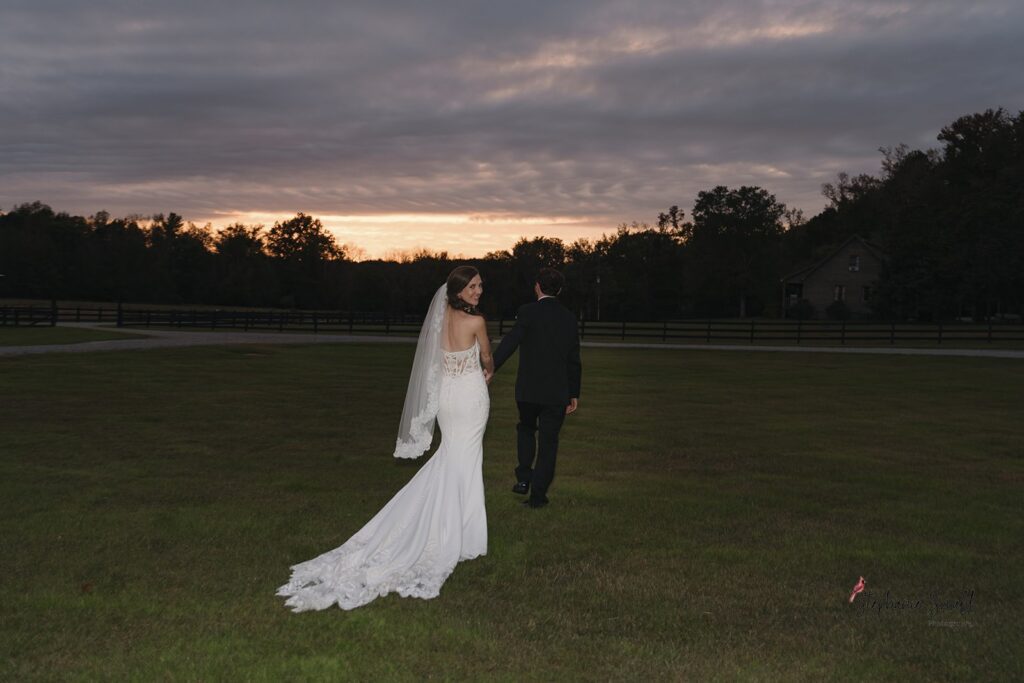 Bride and groom portrait in open field at Oakland Farms wedding venue in Sanford North Carolina
